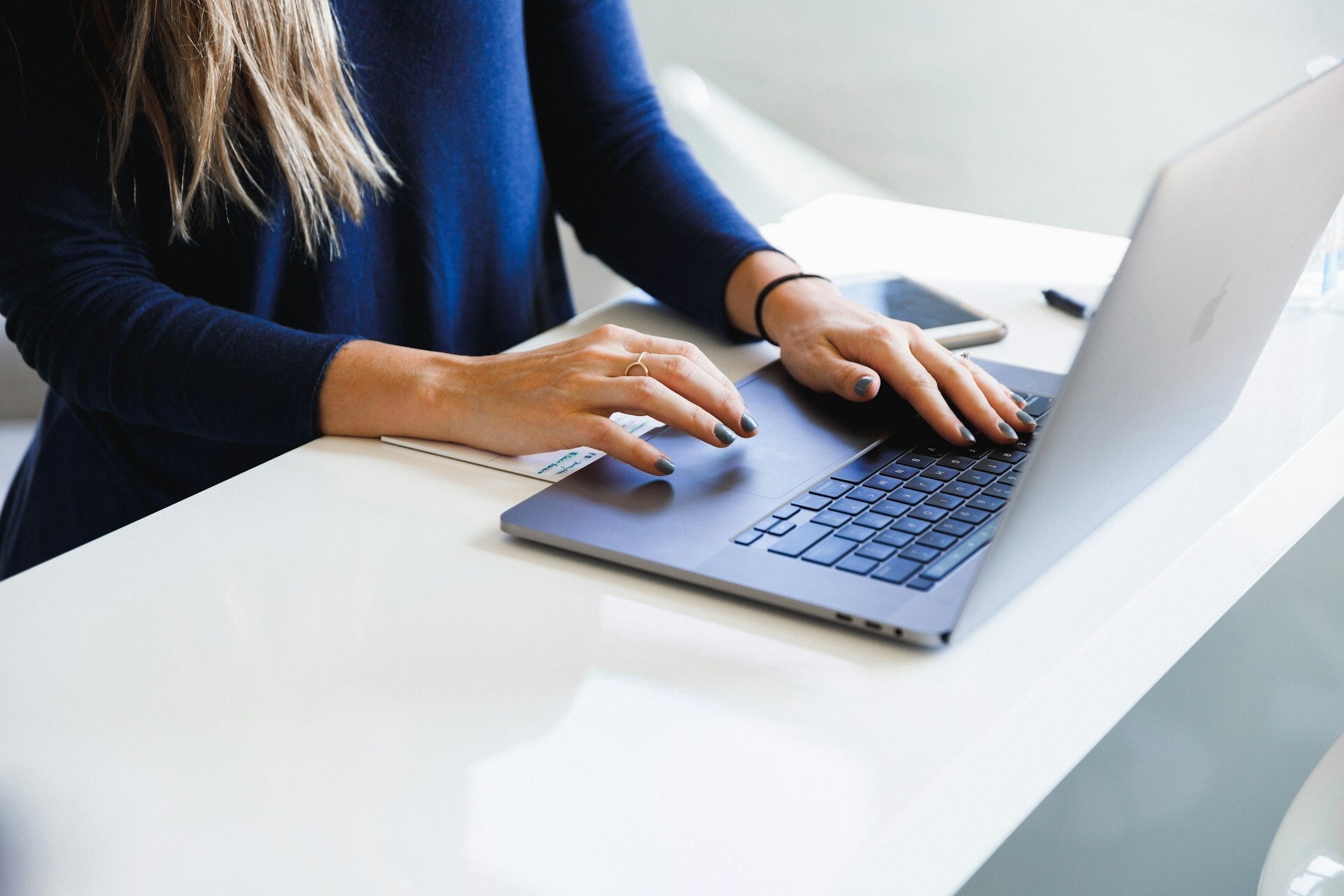 A woman using a laptop at a table